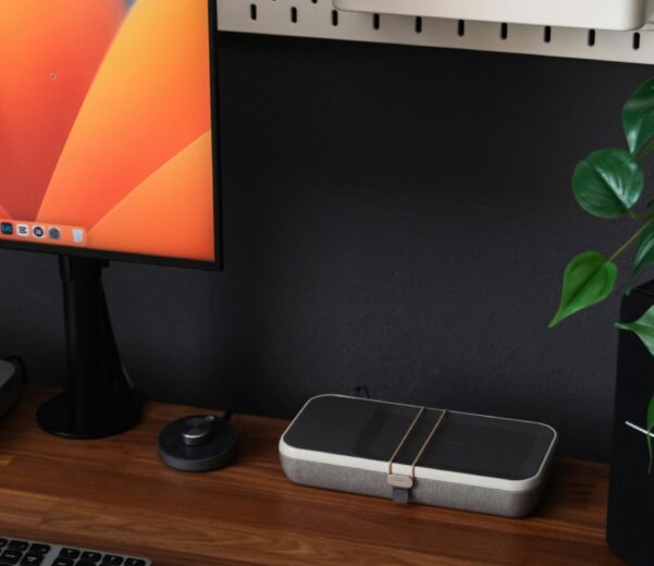 a desk with a laptop, keyboard, mouse and a monitor