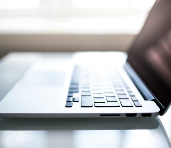 Free Elegant side view of a laptop on a glossy table with natural lighting indoors. Stock Photo